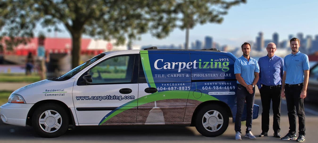 Colin Petts with Thomas Petts and the Carpetizing team beside the company van — family-owned since 1975